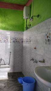a bathroom with a toilet and a sink and a tub at View Porjoton Mairung Gaon Homestay in Rishop