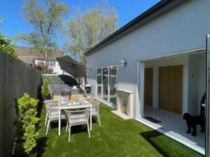 a patio with a table and chairs in a yard at 3 Bed in Barnstaple 87116 in Fremington