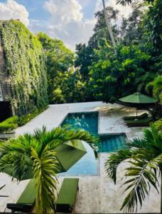a swimming pool in a resort with palm trees at Tropical trails -Unawatuna in Unawatuna