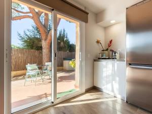 a kitchen with a sliding glass door leading to a patio at Cabril's Hills Luxe Suites in Cabrils