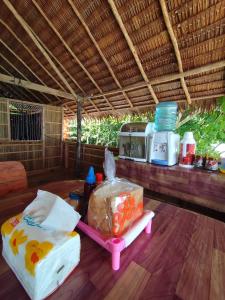 a table with a box of food and a microwave at Batanta Panorama Homestay in Dayang