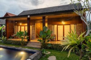 a house with a pool in front of it at Bali Vanili Villa in Sukawati