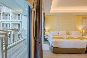 a bedroom with a large bed and a balcony at Aqua Resort Aonang Krabi in Ao Nang Beach
