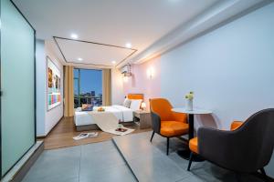 ein Hotelzimmer mit einem Bett und einem Tisch und Stühlen in der Unterkunft Anman Four Seasons Apartment (Beijing Road Pedestrian Street Branch) in Guangzhou