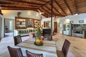 a living room with a table and chairs and a kitchen at Toucan Villa Family home w Private Pool Garden AC in Quepos