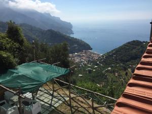 a view of a mountain with the ocean in the background at La Casa Del Nonno Raffaele- Country house in Ravello +25 photos