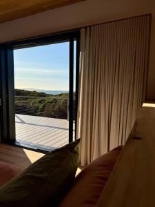 a room with a large window with a view at Sommerhus Danish inspired beach front retreat in Vivonne Bay