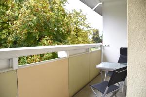 an office with a window and a chair on a balcony at GUWO Gästewohnungen Kaltenborner Straße 156 in Kaltenborn