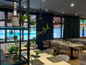 a restaurant with tables and chairs and a bottle of wine at Hotel "Izvor Bosne" in Sarajevo