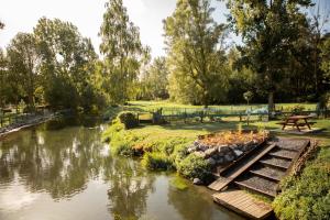 a river in a park with a picnic table at La Cabane de Camille in Pithon