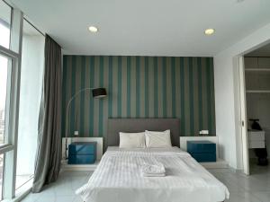 a bedroom with a bed with a green wall at PLATINUM SUITES KLCC by RAISA in Kuala Lumpur +68 photos
