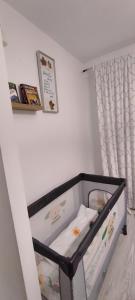 a baby crib in a room with a shelf at Apartament Ziemia Kłodzka in Kłodzko