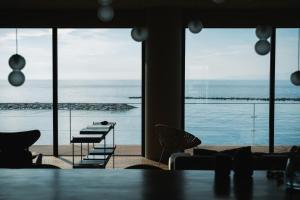a dining room with a view of the ocean at TORIKKA Stay -海だけが見える宿- in Sumoto