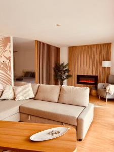 a living room with a couch and a table at Loft Cosy sur le Lac in Bouveret