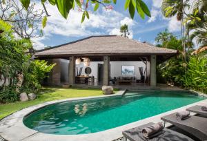 a swimming pool in the backyard of a villa at The Amala Boutique Retreat in Seminyak