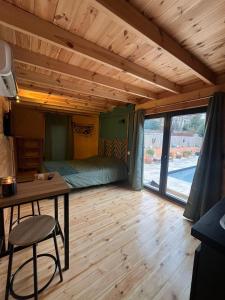 a room with a bed and a desk and a table at Petite villa en bois in Montbazin