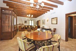 a dining room with a wooden table and chairs at Sinia in Petra