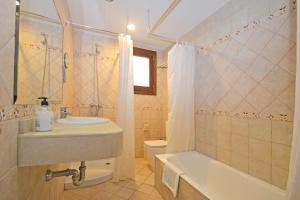 a bathroom with a sink and a tub and a toilet at Sinia in Petra +38 photos