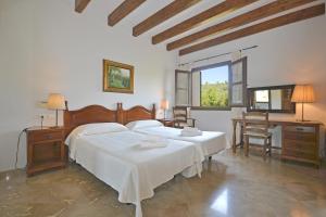 a bedroom with two beds and a desk and a window at Sinia in Petra