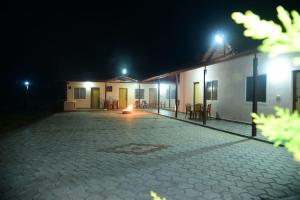a courtyard of a house at night with a fire place at Ganav home stay in Chikmagalūr +9 photos