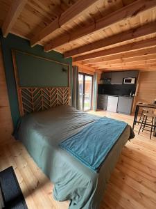 a bedroom with a bed in a log cabin at Petite villa en bois in Montbazin