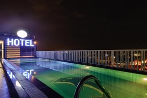 a hotel with a swimming pool at night at Paradise Cu Chi Hotel in Củ Chi