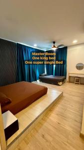 a bedroom with a master room one king bed and one super single bed at LC Paragon Apartment in Labuan