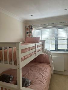 a bunk bed in a room with a bunk bedutenewayewayangering at Lanrest in Talacre