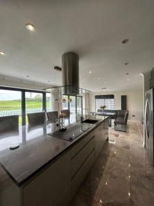 a large kitchen with a large island in the middle at Lanrest in Talacre