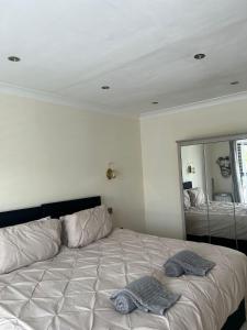 a bed in a bedroom with a large mirror at Lanrest in Talacre