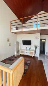 a living room with a tv and a couch at Umacabana 2 in Dieng