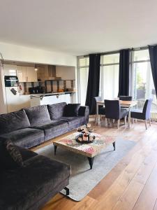 a living room with a couch and a table at Big apartment surrounded by nature in Amsterdam in Ons Belang