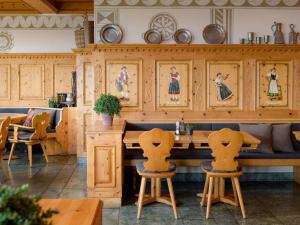 a kitchen with wooden cabinets and a table and chairs at Mövenpick Hotel Egerkingen in Egerkingen