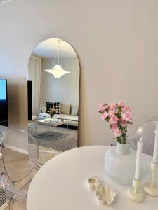 a living room with a white table and a mirror at Beautiful home in the center of Rovaniemi in Rovaniemi