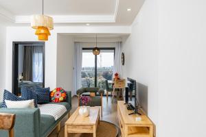 a living room with a couch and a table at Marina Bay One & Two Bedroom Apartment, Swimming pool, gym, workspace ,Wonderiss Homes Westland Living in Nairobi