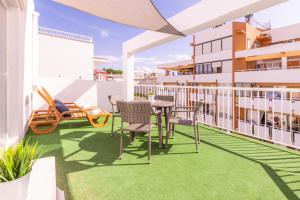 a balcony with a table and chairs on a building at Hotel Boogaloo - Adults Only in El Arenal