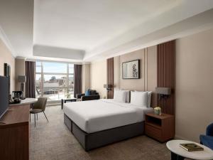 a hotel room with a bed and a living room at Anwar Al Madinah Mövenpick in Al Madinah +181 photos