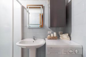 a white bathroom with a sink and a mirror at Macrillo Guest House in Gallio +15 photos