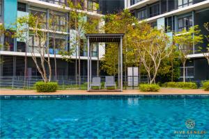 a swimming pool in front of a building at KIP Core Soho Suite by Five Senses in Sepang