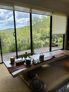 a room with a large window with a view at Ecoasis Mami Wata Rainforest Haven in Uki
