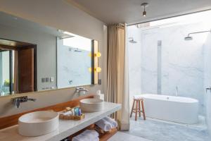 a bathroom with two sinks and a large mirror at Dos Casas Hotel & Spa in San Miguel de Allende +65 photos