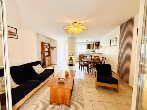 a living room with a couch and a table at Le Cersois,proche Canal du Midi et de la Mer, environnement paisible et parking privé in Cers +23 photos