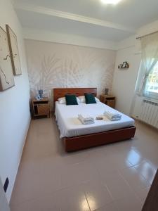 a bedroom with a large bed in a room at Hibiscus Apartment Ciampino Rome Roma in Ciampino