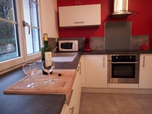 a kitchen with two glasses of wine on a counter at Gîte La Rocardière XL 10 personnes in Mouchamps +25 photos