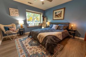 a bedroom with a bed and a chair and a window at Magic Sequoia Spacious Home in Three Rivers