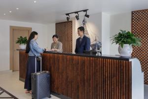 a group of people standing at a reception desk at Hotel Anuttara Boudha, Kathmandu in Baudhatinchule