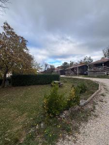 a yard with a bush in the middle of it at Chalet Montana pmr 4 pers in Roquefeuil