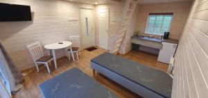 a small room with a bed and a table and a sink at Tuksi Health and Sports Centre in Tuksi