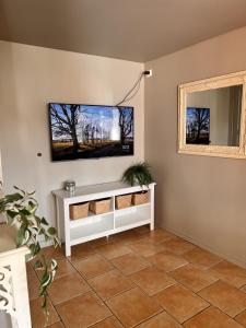 a living room with a tv on the wall at Bright and centrally studio with Oceanview in Kristiansand