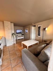 a living room with a couch and a table at Bright and centrally studio with Oceanview in Kristiansand +10 photos